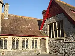 Photograph of the porch with a view of the right side door and stained glass windows
