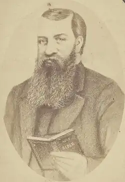 Formal portrait illustration of a younger Dwight Lyman Moody with a full dark beard