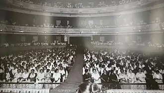 A black and white photograph of hundreds of women seated in the Peón Contreras Theater. Women are seated both in the main seating area and in the balconies.