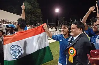 Priyaranjan Dasmunsi and the footballer, Sunil Chetri along with other players celebrating after winning the final