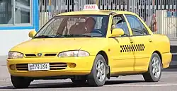 A Proton Wira yellow taxi in Pyongyang.