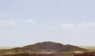 A photograph of the mound of sand that comprises the destroyed remains of the pyramid, called 'Merenre's beauty shines', which belonged to Merenre Nemtyemsaf I.