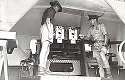 Officers inspect breeches of twin 6pdr gun. 1943.[gallery 18]