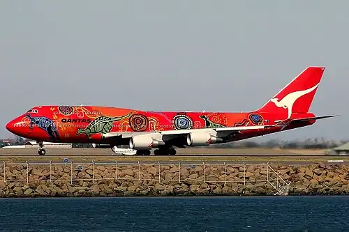A Boeing 747–400ER in 2006 wearing the Wunala Dreaming livery. From 2003 to 2012, it was the second aircraft to carry the colour scheme.