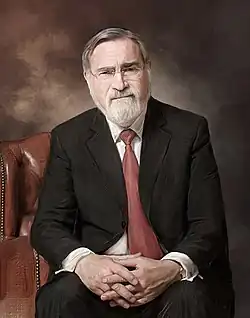 Rabbi Jonathan Sacks smiling at the camera.