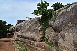 Cave temple seen from the side, with steps up a rock