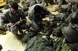 Two Rangers inspect their gear before the Ranger Rendezvous, a mass tactical jump conducted by elements from the entire Regiment, August 3, 2009