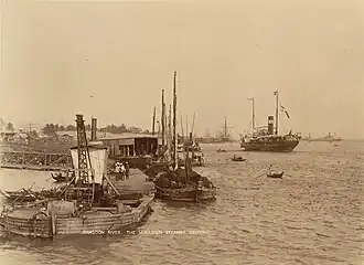 Image 36The paddle steamer Ramapoora (right) of the British India Steam Navigation Company on the Rangoon river having just arrived from Moulmein. 1895. Photographers: Watts and Skeen. (from History of Myanmar)