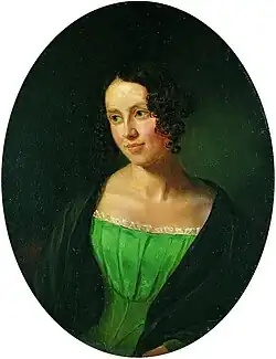 Portrait of a young lady. She is wearing a dress under a coat. She is looking to the left, somewhat smiling.