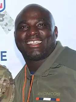 Reuben Droughns from about the chest up smiling.