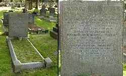 A granite headstone in the shade of a tree, surrounded by other gravestones