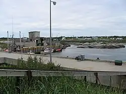 Fishermen's wharf,[19] sheds, fishing vessels and zodiac, Tonnerre River