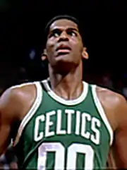 A man, wearing a green jersey with a word "CELTICS" and the number "00" written in the front, is looking up.