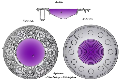 A large circular glass lens with a flat top and a stepped domed bottom. The glass is purple, with the shade darkening towards the top. The glass is set in a wide and ornate circular frame engraved with a semi-geometric ring-of-roundels design that looks a bit Art Deco, although from 1834.