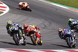 Valentino Rossi, Marc Márquez and Maverick Viñales racing at the 2016 Austrian Grand Prix.