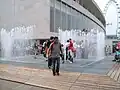 Walking through the Appearing Rooms fountain installation, by Danish artist Jeppe Hein, outside the RFH during reopening celebrations after 2007 refurbishment.