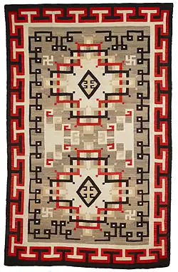 A wool rug ca.1900-1920 from the Navajo people in the Early Crystal style, with key patterns forming the outer border.