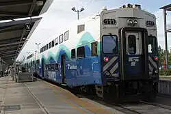 A double-decker passenger car in the Sounder livery with "111" displayed on two signs at its rear