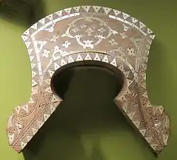 Carved saddle panel of the Yakan people, inlaid with shells