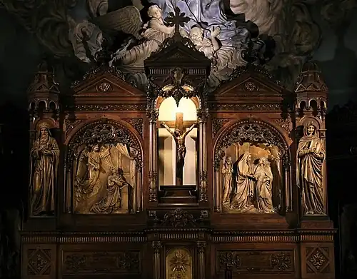 The carved retable with scenes from the life of Saint Mary