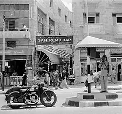 Traffic officer in front of a bar, 1955