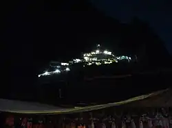 illuminated temple shrine seen in the dark hill