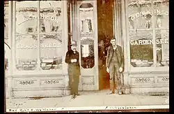 Two men stand in front of Dickinson's Seed Storefront in the 1860s.