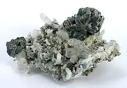 A spray of semseyite crystals perched, freestanding, at the apex of a cluster of quartz crystals. Herja Mine (Kisbánya), Baia Mare (Nagybánya), Maramureș County, Romania