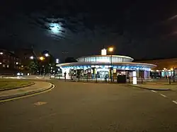 Southgate Station at night with a full moon