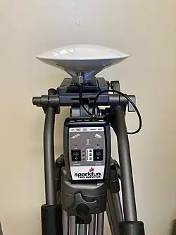 A GIS system consisting of a tripod, antenna, and Sparkfun RTK Surveyor