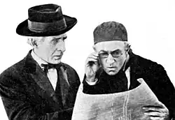 Two men in period costume, in conversation