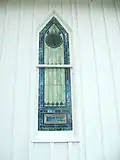 A stained glass window of the church