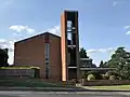 St Michael and All Saints Roman Catholic Church, built 1961-4 by Henry Bingham Towner and officially opened by Archbishop Cyril Cowderoy[4]