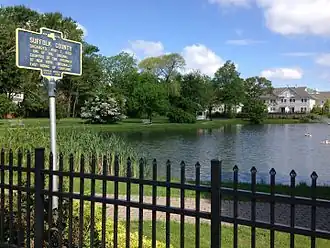 Sign referring to Suffolk County's 1683 founding located in Peterkin Park on Oak Street in Amityville.