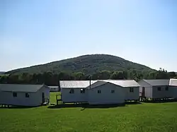 Sugarloaf Mountain viewed from the nameless hill above Elkview, with camp buildings in the foreground.