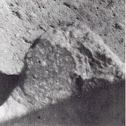 Spotted fragment about 1.5 meters from Surveyor 7 camera. Bright spots have indistinct boundaries and vary from less than 1&nbsp;mm to about 8&nbsp;mm across.