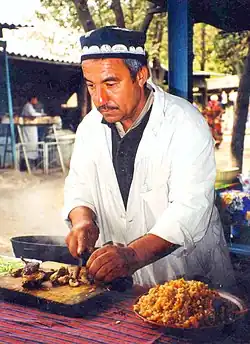 Image 8A man makes plov, the national dish of Tajikistan. (from Culture of Tajikistan)