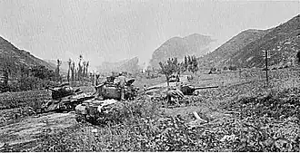 A tank advances into a valley