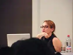 Tatiana Bilbao staring at a laptop in front of a crowd