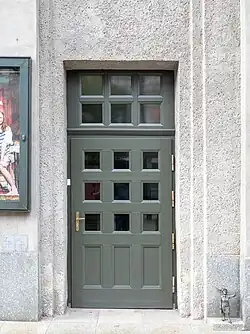 Door on Warszawska Street, with a tiny statue of Krystyna Bochenek