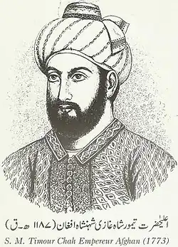 A black and white portrait, from the chset up, of a bearded and turbaned man