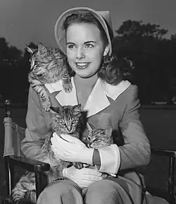 Moore seated with three cats in 1947