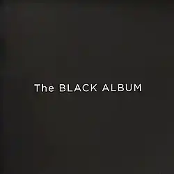 The words "The BLACK ALBUM" in a large, white font against a black background