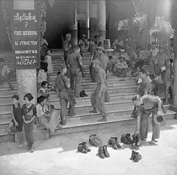 Image 4British soldiers remove their shoes at the entrance of Shwedagon Pagoda. To the left, a sign reads "Foot wearing is strictly prohibited" in Burmese, English, Tamil, and Urdu. (from Culture of Myanmar)