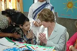 The First lady of USA, Ms. Laura Bush interacting with a child on her visit to Mother Teresa Light of Life Home (Jeevan Jyothi) for disabled children, in New Delhi on 2 March 2006.