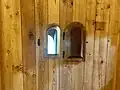 The leper window near the altar in the Hopperstad Stave Church Replica allowed the individuals with Leprosy to see the service and receive communion while remaining outside of the church.