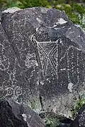Anthropomorphic figure decorated with abstract designs.