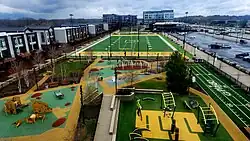View of a playground, football field, and park