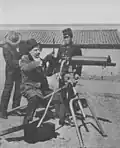 A foreign instructor demonstrating a Maxim machine gun to a Korean soldier. Acquired from Great Britain in (Unknown).