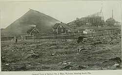 Above-ground portion of the No. 2 Mine with a huge pile of mined ore (early 20th century) next to it. Such heaps were built in winter, as shipping was then at a standstill.[39]